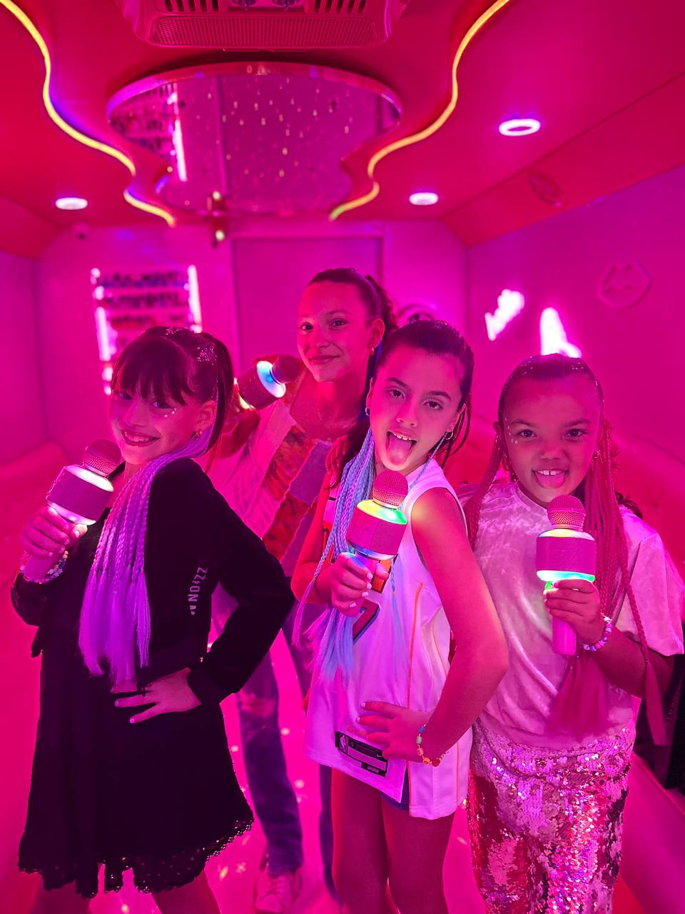 Girls singing karaoke on the bus